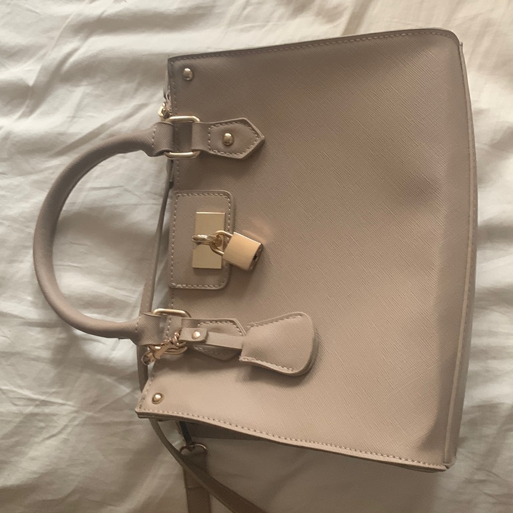 Woman's tan shoulder handbag with adjustable strap. Excellent condition